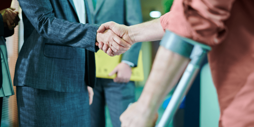 An injured person shaking hands with a lawyer to begin a personal injury lawsuit process.